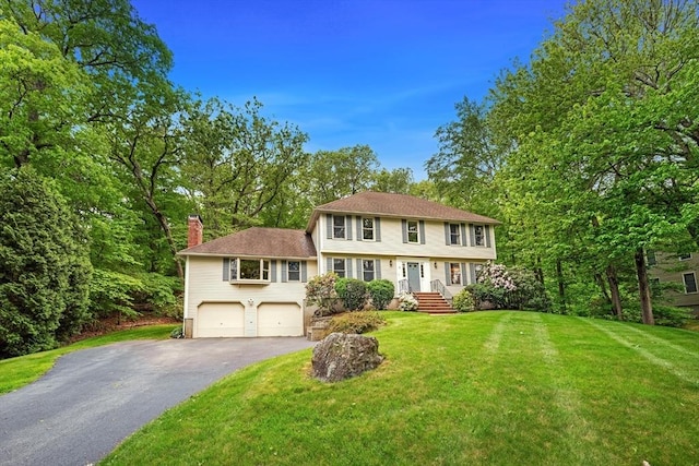 4 Ravens Blf, Andover, MA 01810 - colonial-style house featuring a chimney, asphalt driveway, a garage, and a front lawn