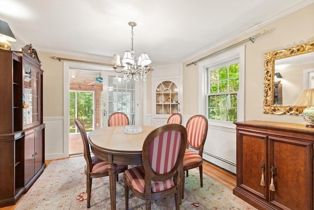 3 Marshall St, North Reading, MA 01864 - dining room featuring a chandelier, light wood-type flooring, a baseboard radiator, crown molding, and plenty of natural light