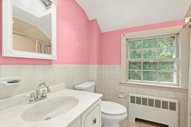 3 Marshall St, North Reading, MA 01864 - full bathroom featuring radiator, vanity, tile walls, lofted ceiling, and a shower with curtain