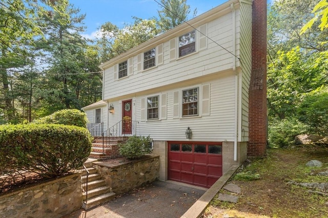 3 Marshall St, North Reading, MA 01864 - colonial house featuring a garage, asphalt driveway, and a chimney