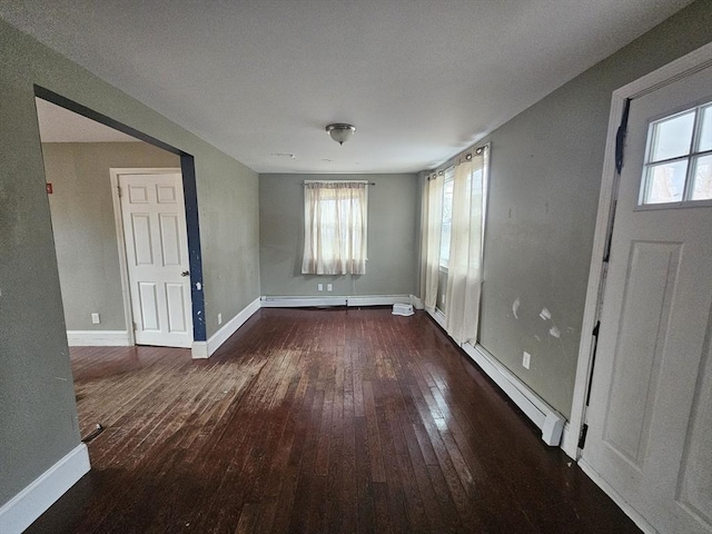 foyer entrance with baseboard heating and dark hardwood / wood-style flooring