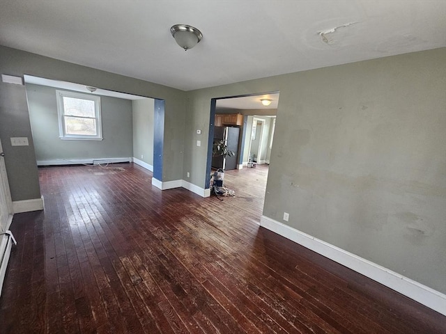 unfurnished room with dark hardwood / wood-style flooring