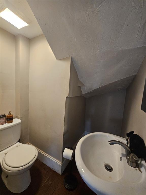 bathroom featuring sink, hardwood / wood-style floors, and toilet