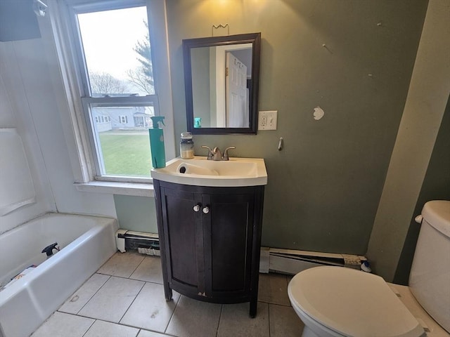 bathroom featuring toilet, vanity, tile patterned floors, a tub, and baseboard heating