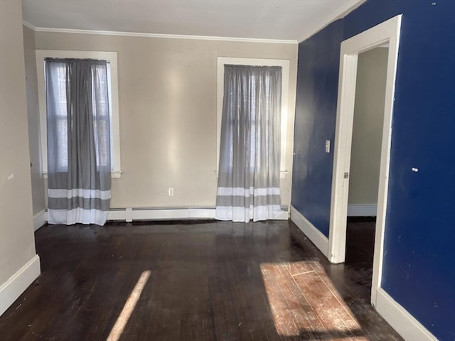 empty room with baseboard heating, dark hardwood / wood-style floors, and ornamental molding