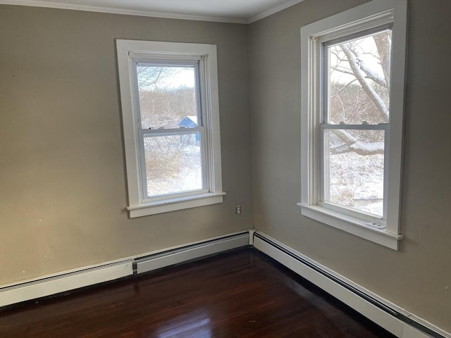 spare room featuring dark wood-type flooring, ornamental molding, and a baseboard radiator