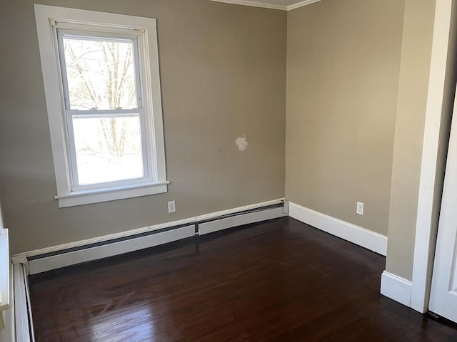 unfurnished room with dark wood-type flooring, baseboard heating, and crown molding