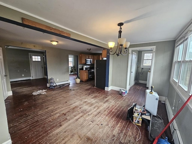 unfurnished dining area with dark wood-type flooring, baseboard heating, ornamental molding, and a chandelier