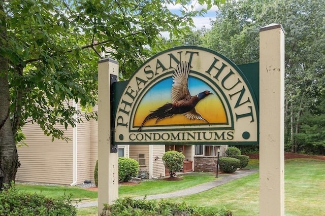 community / neighborhood sign featuring a lawn