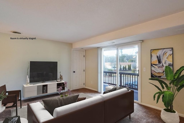 carpeted living area featuring visible vents and baseboards