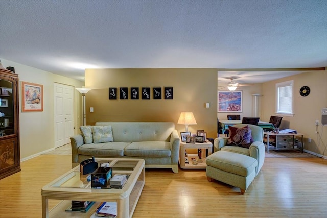 15 Foundry St Unit B1, Easton, MA 02375 - living area featuring light wood-style floors, a ceiling fan, a textured ceiling, and baseboards