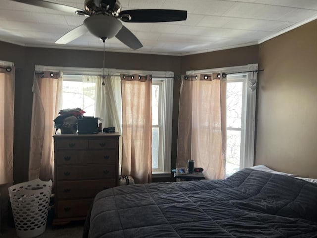 bedroom featuring a ceiling fan and crown molding