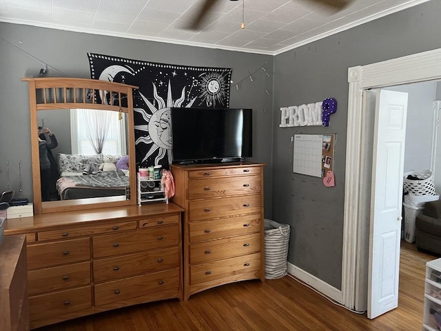 bedroom with baseboards and wood finished floors