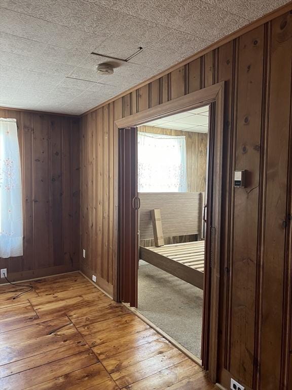 interior space with wooden walls and hardwood / wood-style flooring