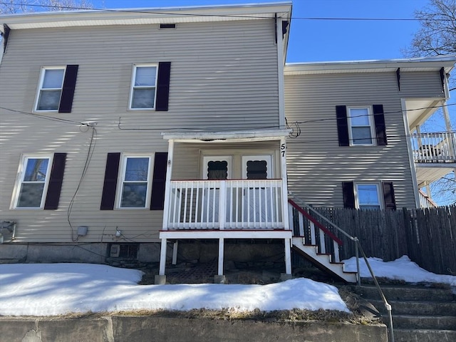 view of front of property with stairway and fence