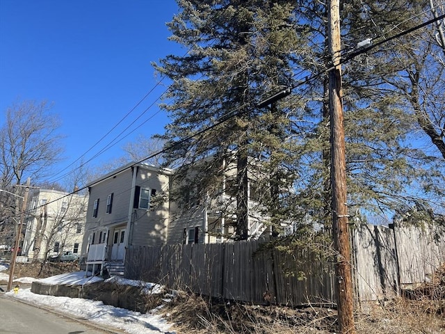 view of side of home featuring fence