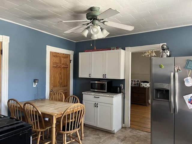 kitchen with ceiling fan, appliances with stainless steel finishes, and white cabinets