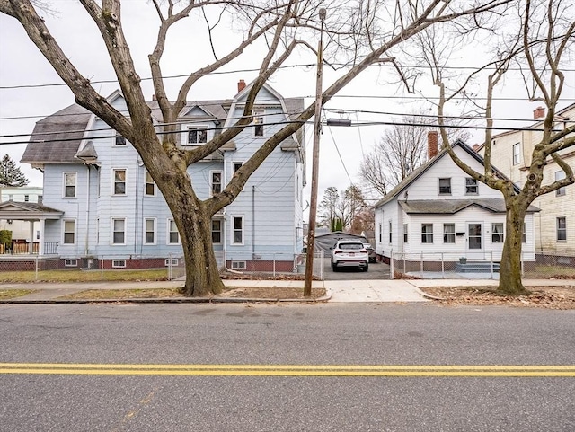 townhome / multi-family property with driveway, fence, and a residential view