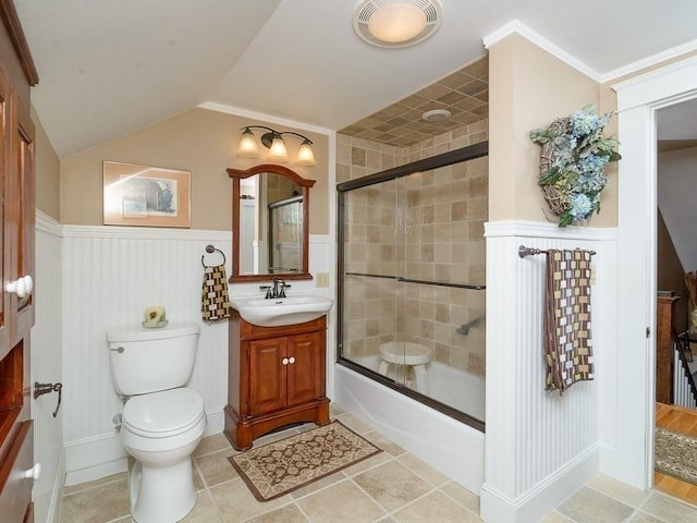 full bathroom featuring bath / shower combo with glass door, vaulted ceiling, vanity, and toilet