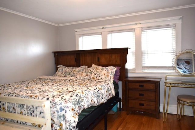 bedroom featuring crown molding, dark wood-type flooring, and baseboard heating