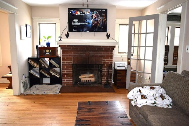 living room with a fireplace and light hardwood / wood-style flooring