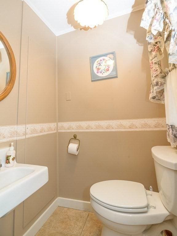 bathroom featuring tile patterned floors and toilet