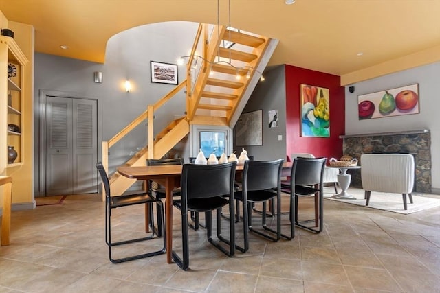 dining room featuring tile patterned floors and stairs