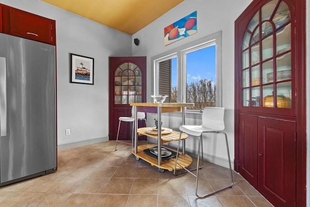 dining area with light tile patterned floors and baseboards