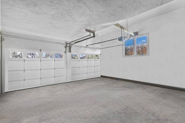 garage featuring a garage door opener and baseboards