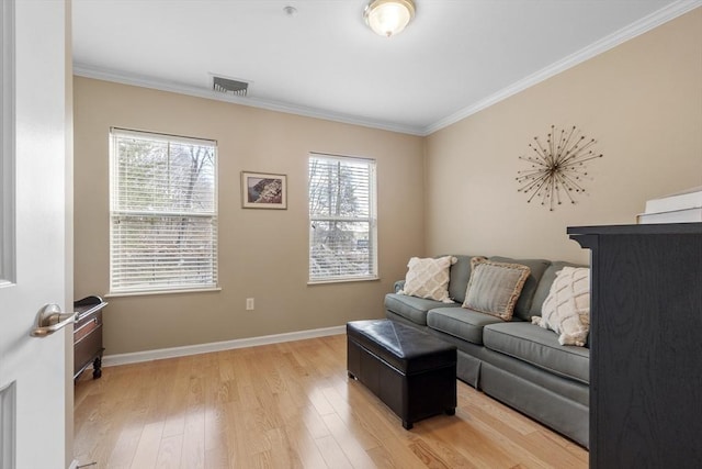 living room featuring wood-type flooring, ornamental molding, and plenty of natural light