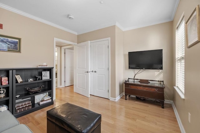 living room featuring ornamental molding and light wood-type flooring