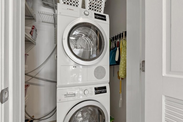 washroom featuring stacked washer / dryer