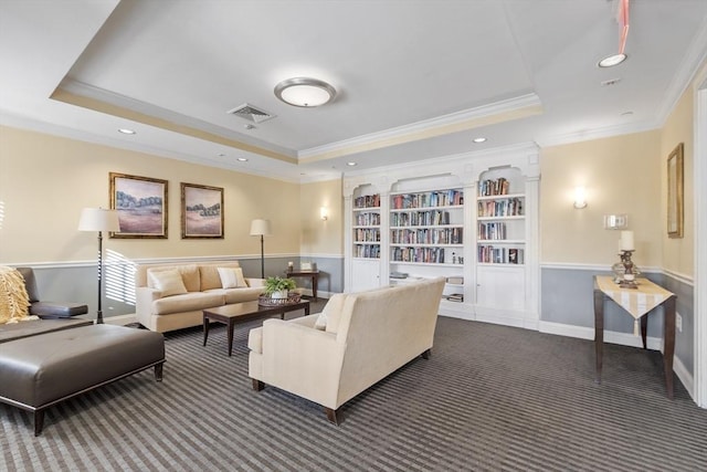 living room featuring ornamental molding, a tray ceiling, and dark carpet