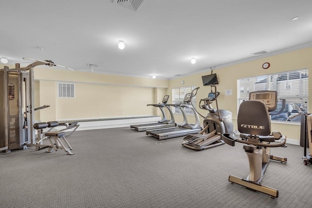 workout area featuring crown molding