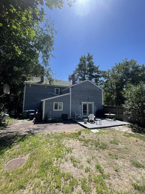 190 Main St, Reading, MA 01867 - back of property featuring a chimney, a deck, and a patio area