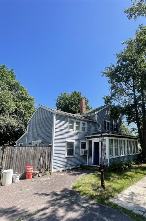 190 Main St, Reading, MA 01867 - view of front of property with a chimney and a sunroom