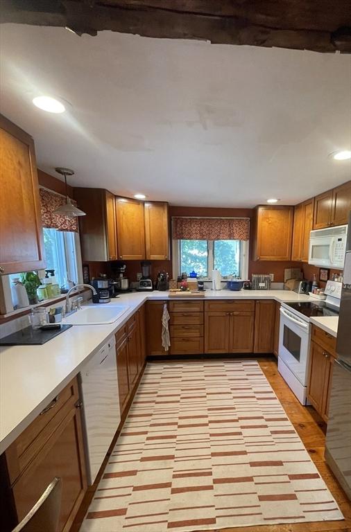 190 Main St, Reading, MA 01867 - kitchen with white appliances, brown cabinets, recessed lighting, light countertops, and light wood-style floors