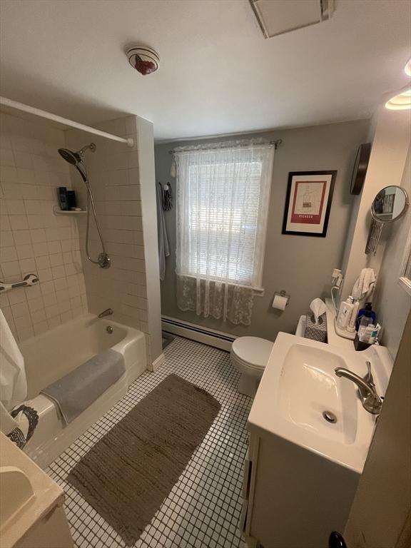 190 Main St, Reading, MA 01867 - bathroom featuring a baseboard radiator, vanity, shower / tub combo with curtain, and tile patterned flooring