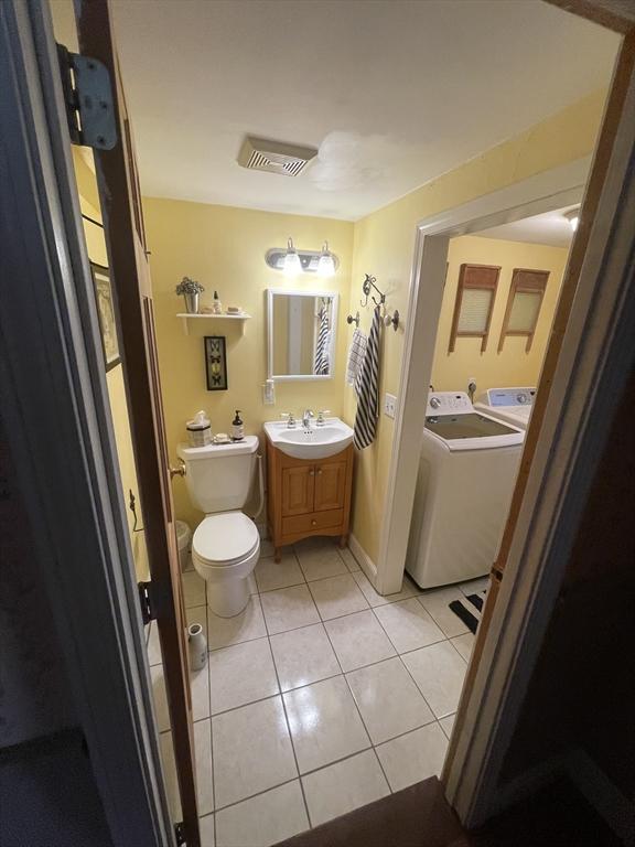 190 Main St, Reading, MA 01867 - bathroom with washer / clothes dryer, tile patterned floors, and vanity
