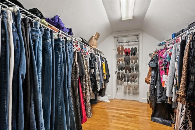 spacious closet with wood finished floors and lofted ceiling
