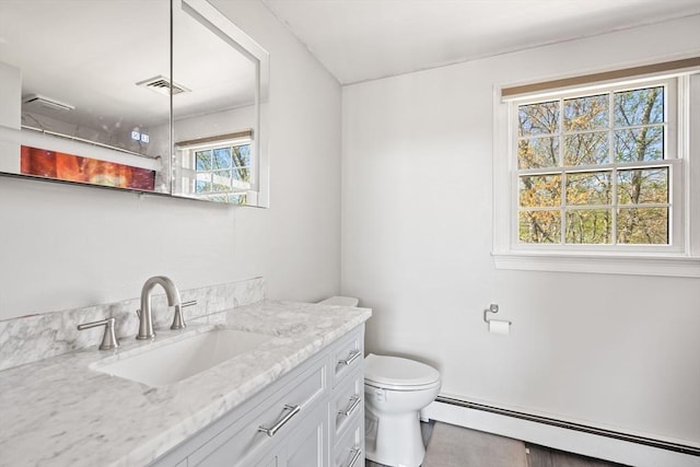 bathroom with vanity, a baseboard radiator, visible vents, and toilet
