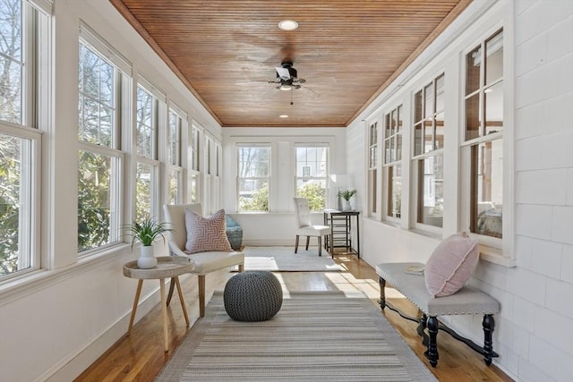 sunroom / solarium with wood ceiling and ceiling fan