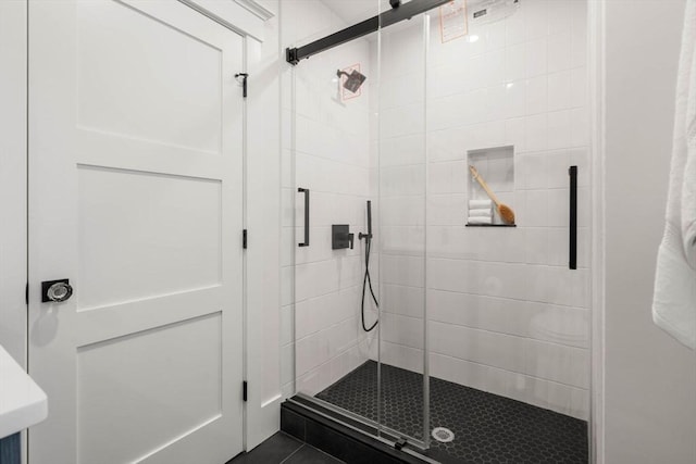 bathroom featuring tile patterned floors and an enclosed shower