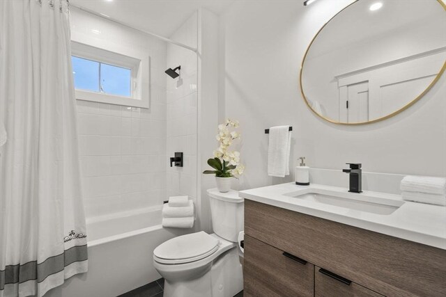 full bathroom featuring shower / bath combo, vanity, and toilet