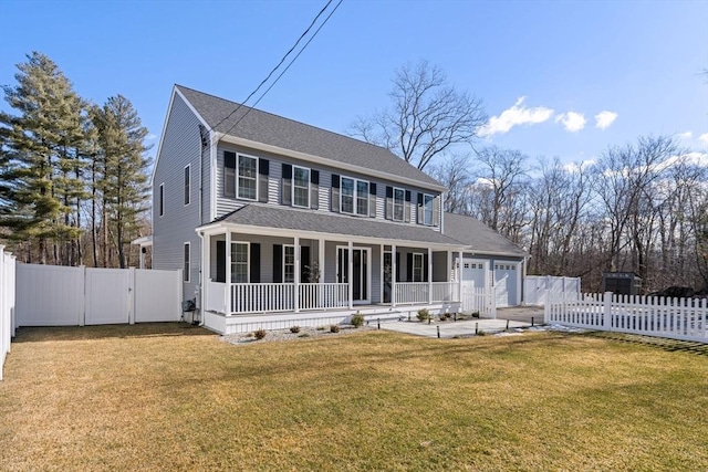 colonial-style house featuring a porch, fence private yard, an attached garage, and a front yard