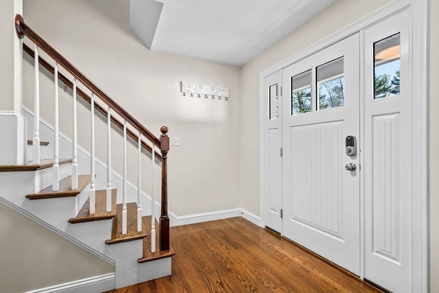 entryway featuring stairs, wood finished floors, and baseboards