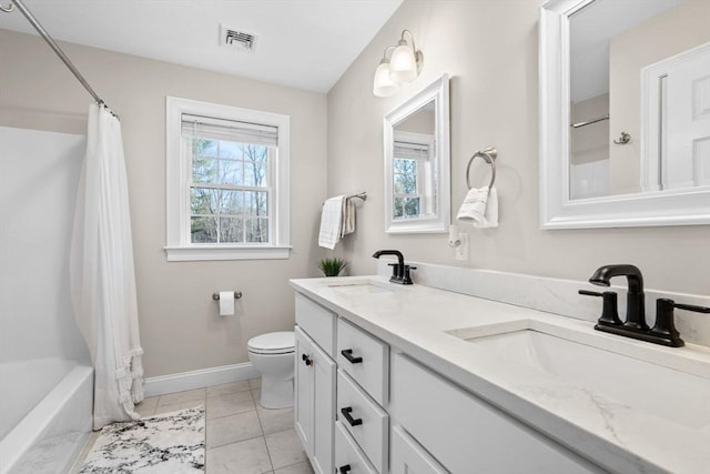 bathroom featuring a wealth of natural light, visible vents, and a sink