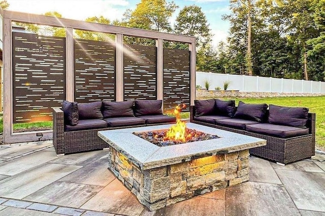 view of patio / terrace with fence and an outdoor living space with a fire pit