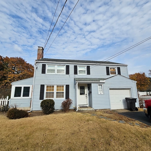 view of front of house with a garage and a front lawn