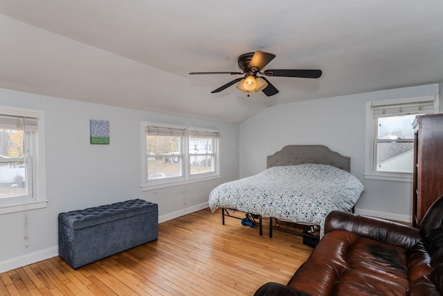 bedroom featuring ceiling fan, light wood-type flooring, and lofted ceiling